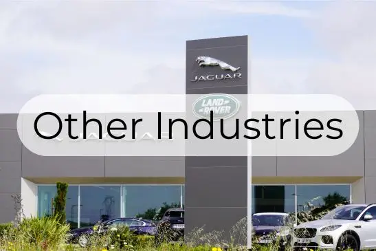 Text reading "Other Industries" over a background of a car dealership