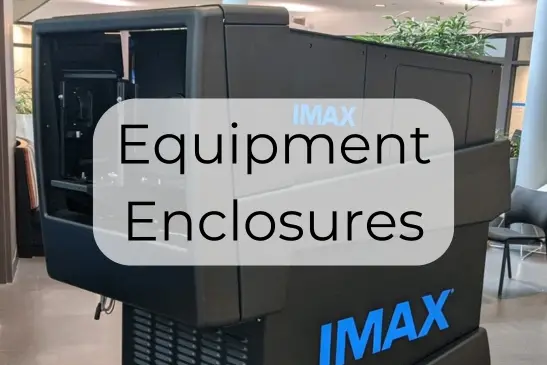 Text reading "Equipment Enclosures" over a background of an IMAX projector
